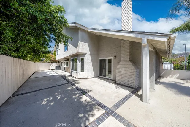 an aerial view of a house with a yard and garden in front