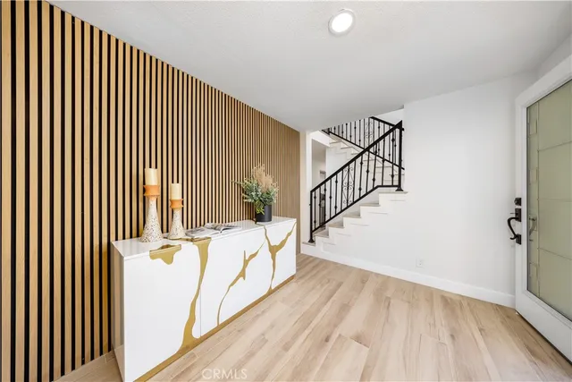 a view of a hallway with wooden floor and staircase
