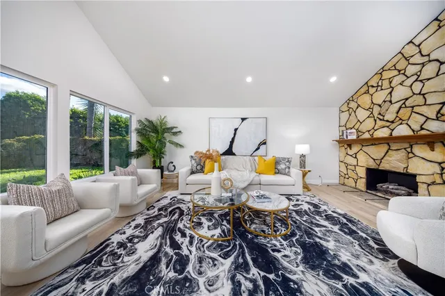 a living room with furniture fireplace and a fireplace