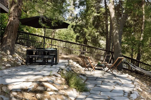a view of a chairs and table in backyard
