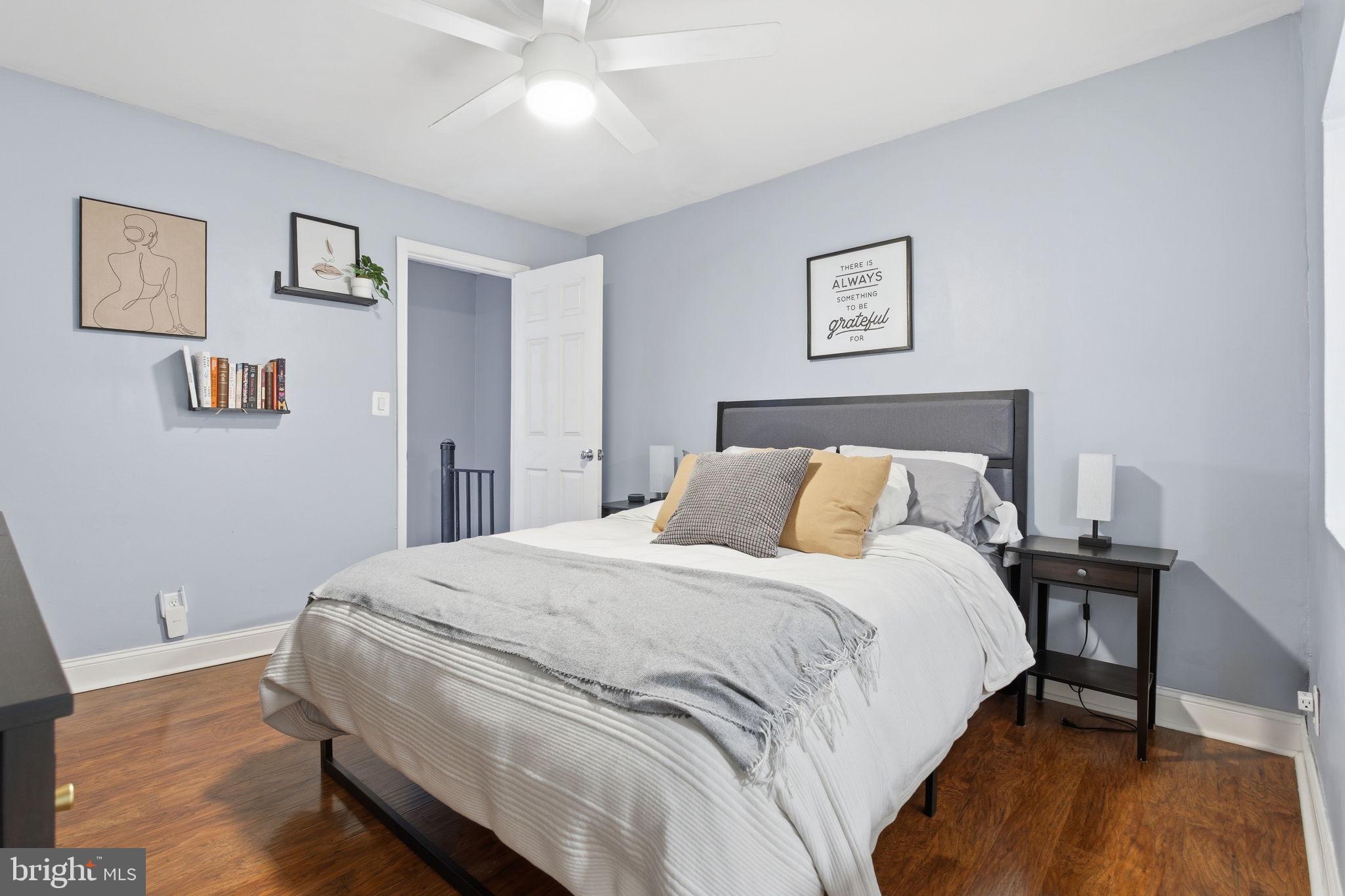 1433 Patapsco Street Baltimore, MD 21230 - Photo 11 of 26 a bedroom with a bed and a lamp on table