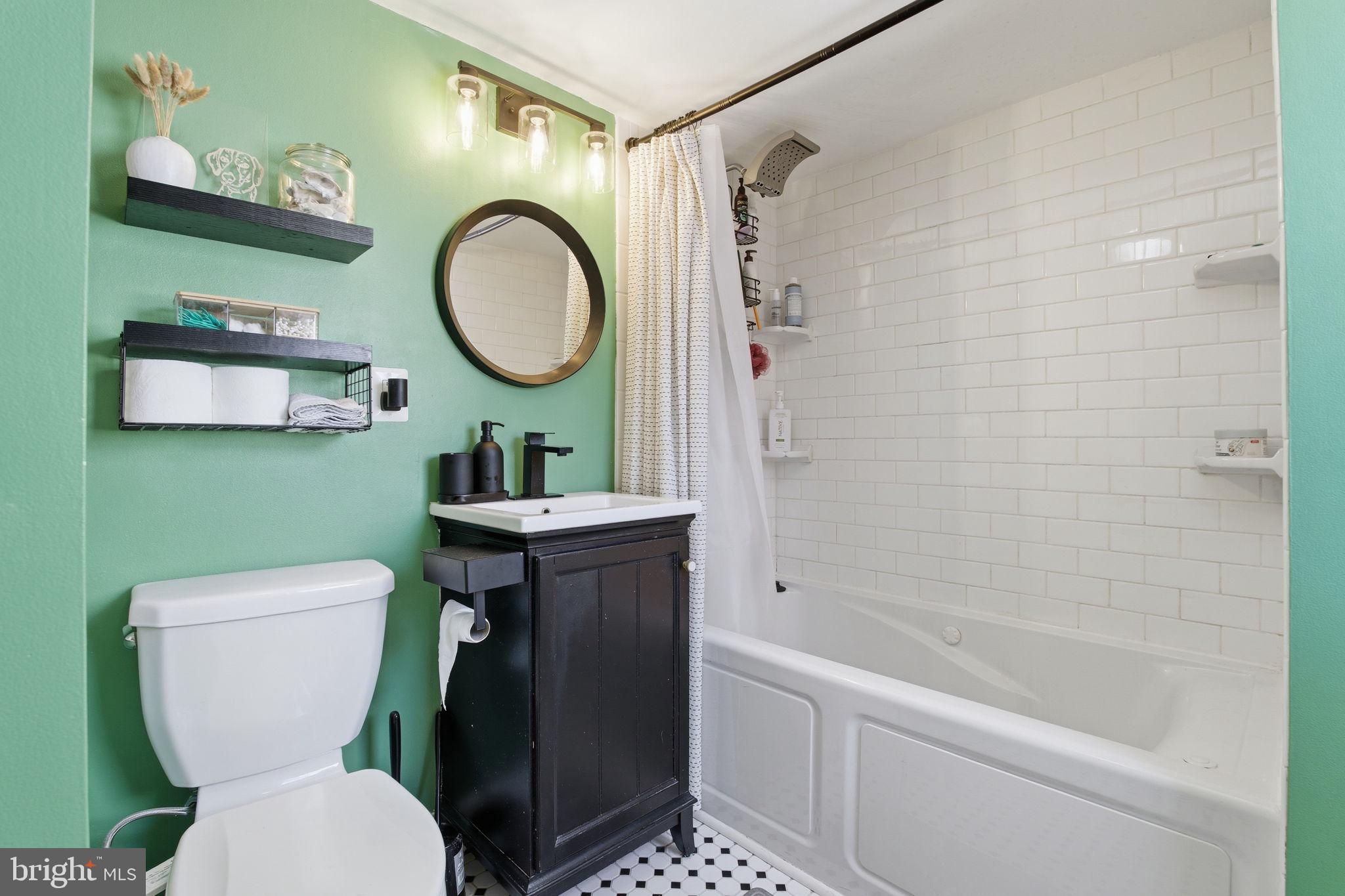 1433 Patapsco Street Baltimore, MD 21230 - Photo 17 of 26 a bathroom with a toilet a sink and a bathtub