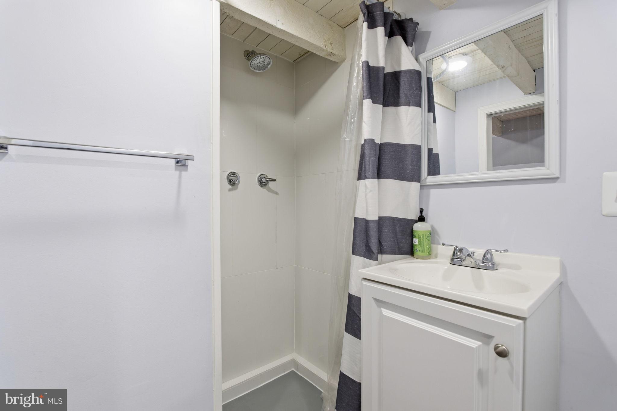 1433 Patapsco Street Baltimore, MD 21230 - Photo 20 of 26 a bathroom with a sink and a mirror