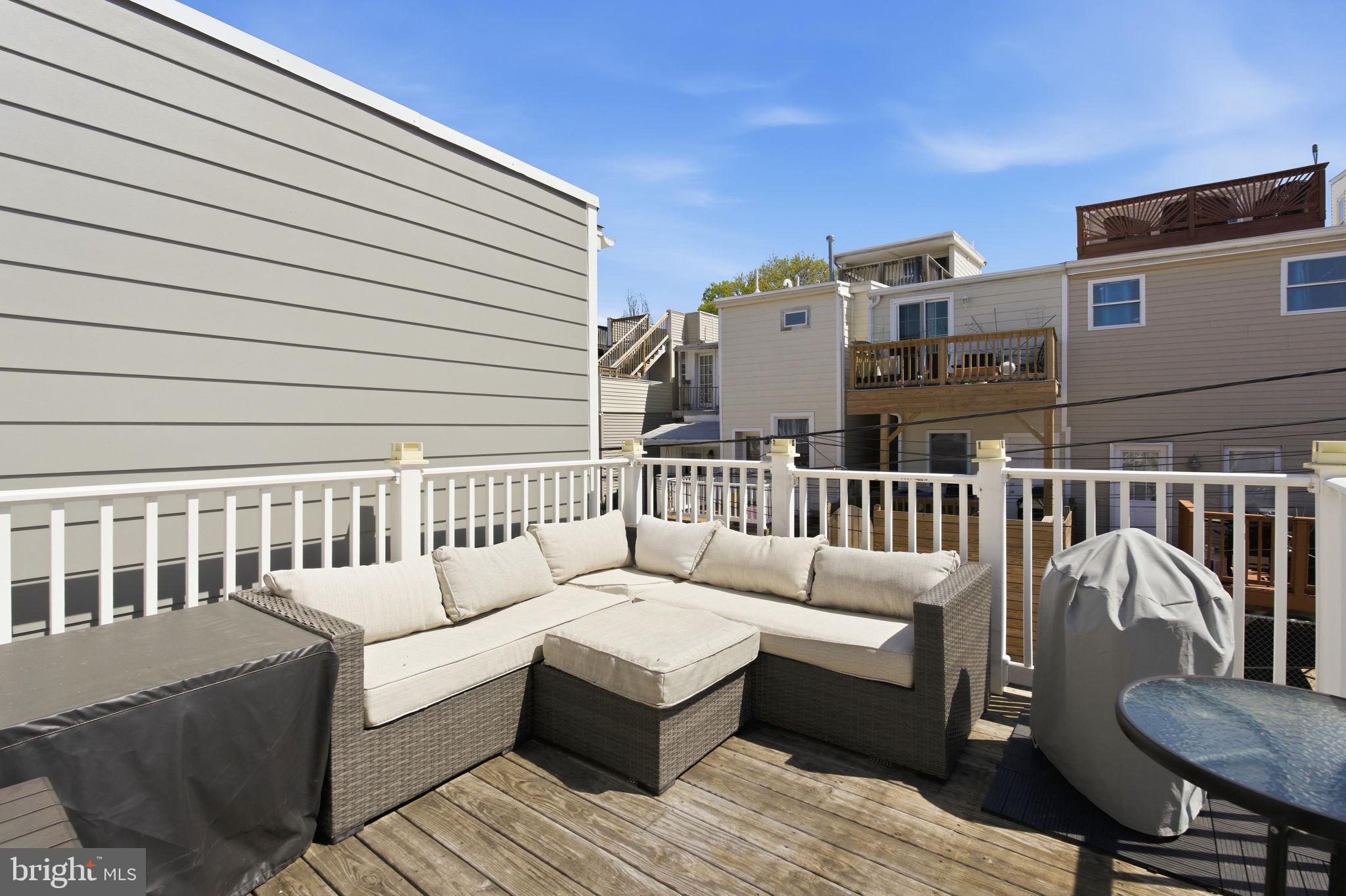 1433 Patapsco Street Baltimore, MD 21230 - Photo 23 of 26 a roof deck with couches and wooden floor