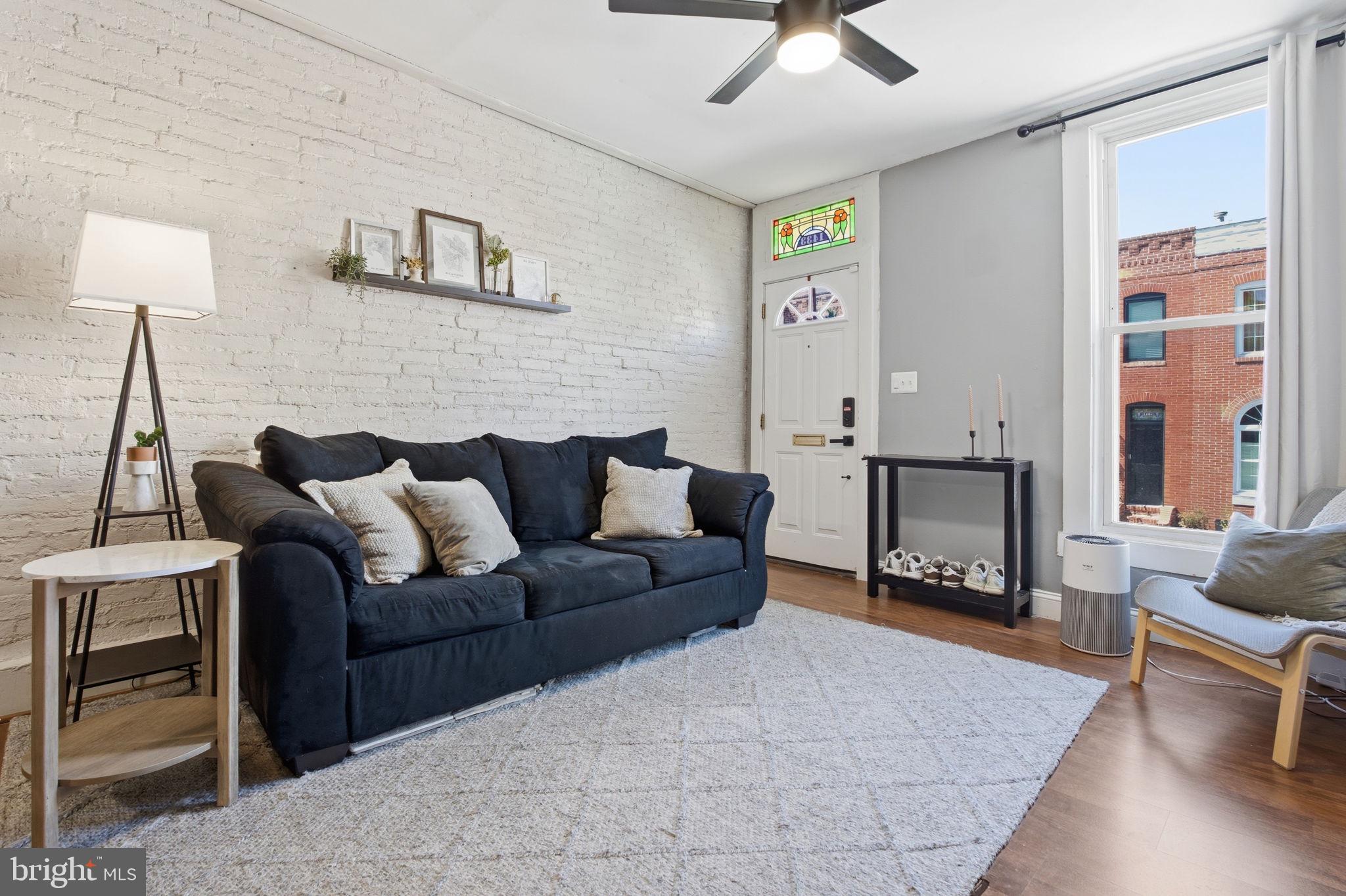 1433 Patapsco Street Baltimore, MD 21230 - Photo 5 of 26 a living room with furniture and a fireplace