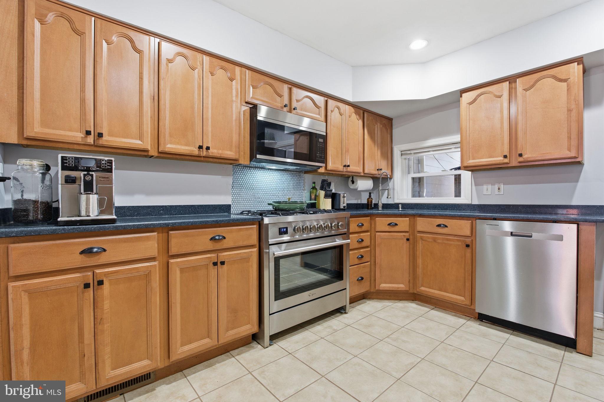 1433 Patapsco Street Baltimore, MD 21230 - Photo 7 of 26 a kitchen with white cabinets sink and stainless steel appliances