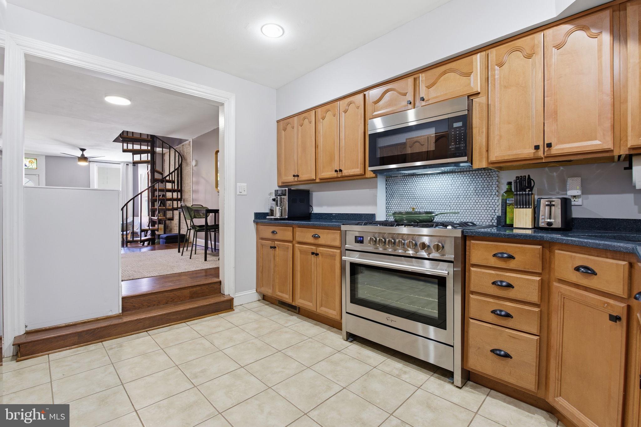 1433 Patapsco Street Baltimore, MD 21230 - Photo 8 of 26 a kitchen with stainless steel appliances granite countertop a stove a sink and a microwave