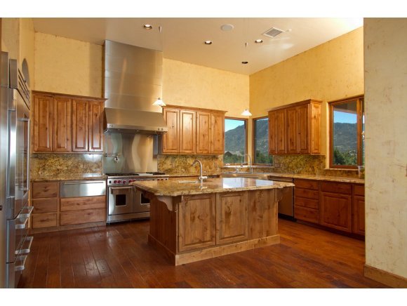 4465 Fort Bridger Road Prescott, AZ 86305 - Photo 5 of 23 a kitchen with stainless steel appliances granite countertop a stove a sink and a refrigerator