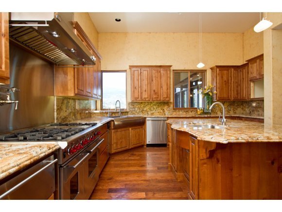 4465 Fort Bridger Road Prescott, AZ 86305 - Photo 6 of 23 a kitchen with stainless steel appliances granite countertop a sink a stove and a wooden cabinets