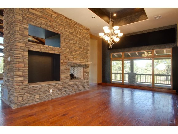 4465 Fort Bridger Road Prescott, AZ 86305 - Photo 8 of 23 a view of a livingroom with a large window wooden floor and front door