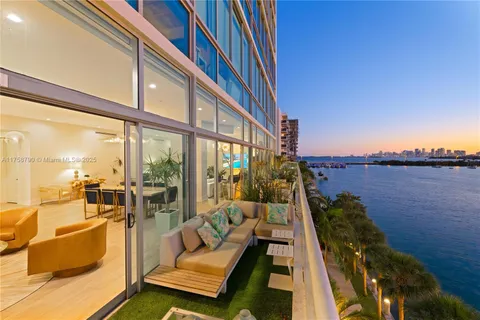 a living room with furniture stove and a large window