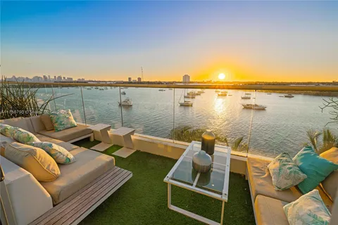 a view of a terrace with couches and wooden floor
