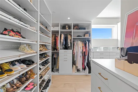 a bedroom with bed and a chandelier