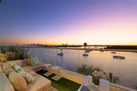 a view of a lake from balcony with seating space