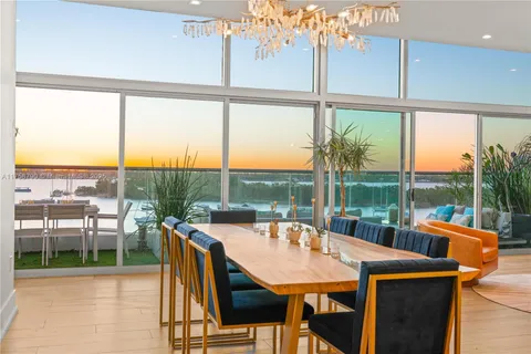 a view of a city from a dining room with a table or chairs