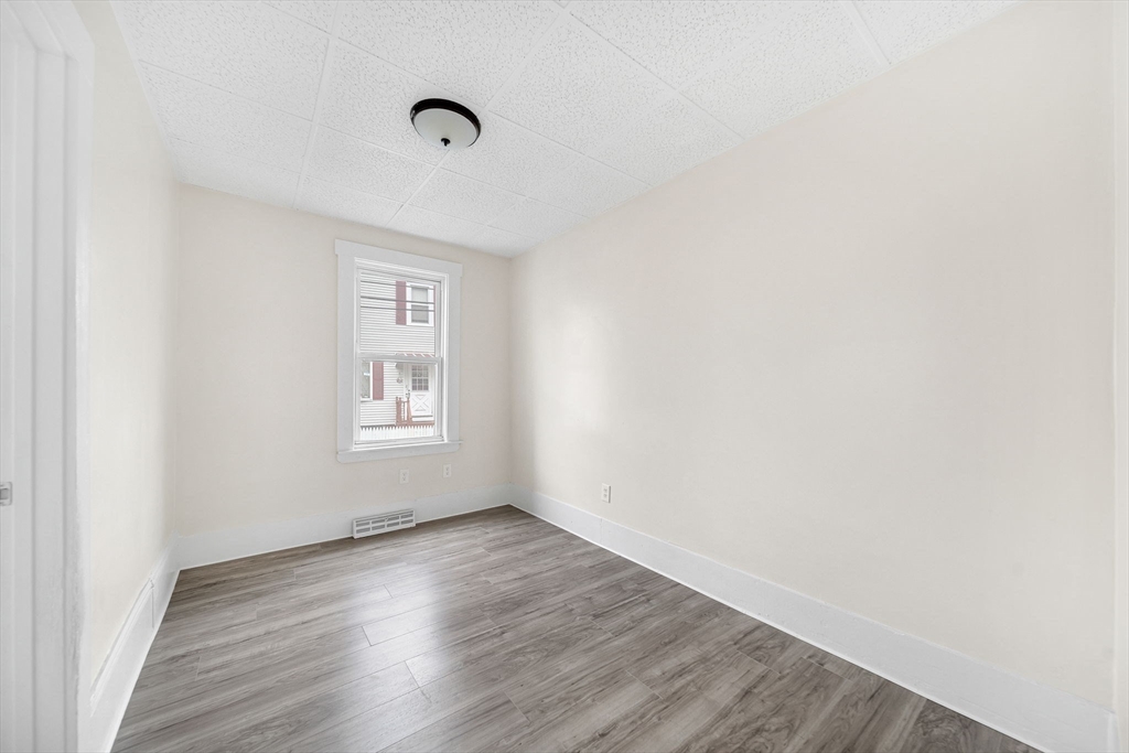 20 Autumn Street Somerville, MA 02145 - Photo 11 of 34 a view of an empty room with wooden floor and a window