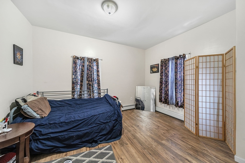 20 Autumn Street Somerville, MA 02145 - Photo 20 of 34 a bed room with furniture and a wooden floor