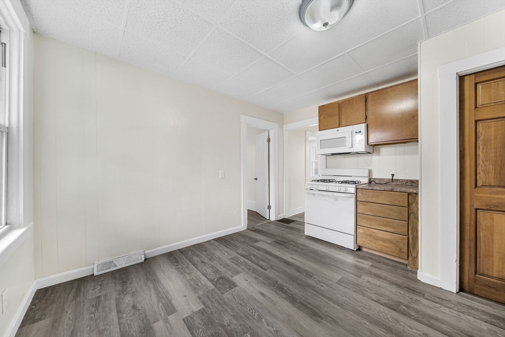 20 Autumn Street Somerville, MA 02145 - Photo 6 of 34 a kitchen with a refrigerator and white cabinets