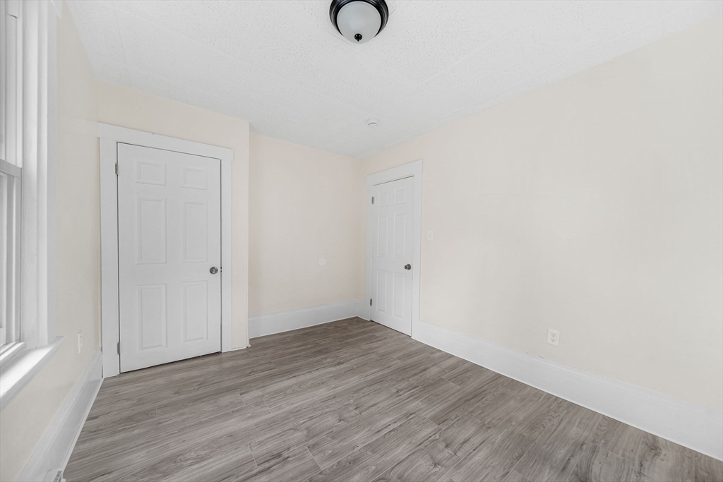 20 Autumn Street Somerville, MA 02145 - Photo 9 of 34 a view of an empty room with wooden floor