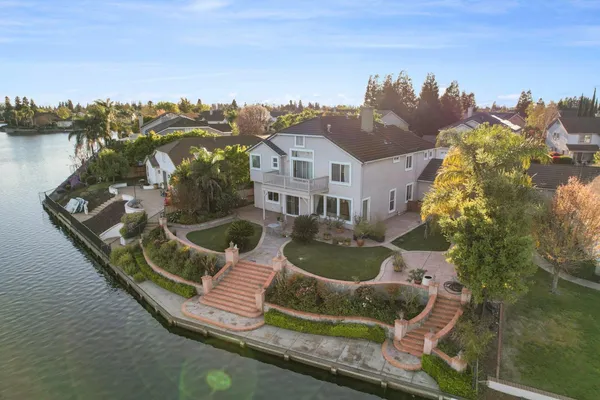 an aerial view of residential houses with outdoor space and ocean view