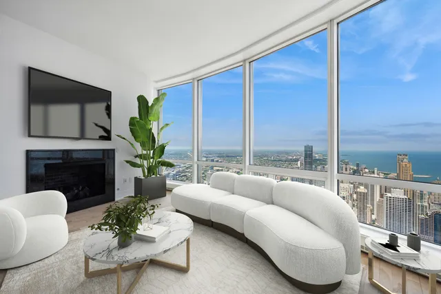a living room with furniture potted plant a fireplace and a flat screen tv