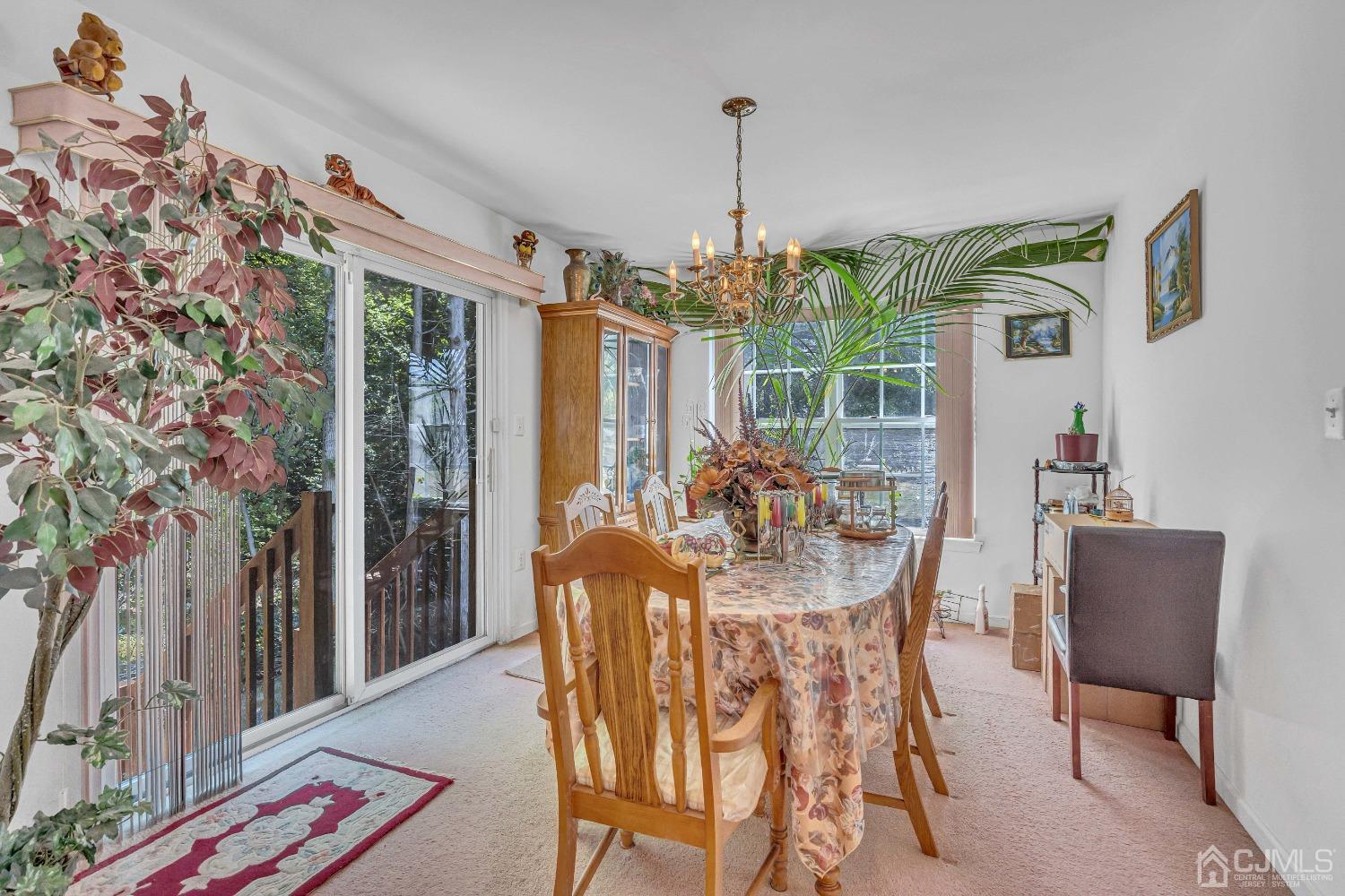8 Fitzgerald Place Old Bridge, NJ 08857 - Photo 11 of 30 a dining room with furniture wooden floor a chandelier and a rug