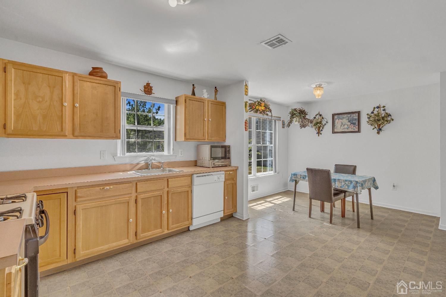 8 Fitzgerald Place Old Bridge, NJ 08857 - Photo 13 of 30 a kitchen with cabinets and chairs in it