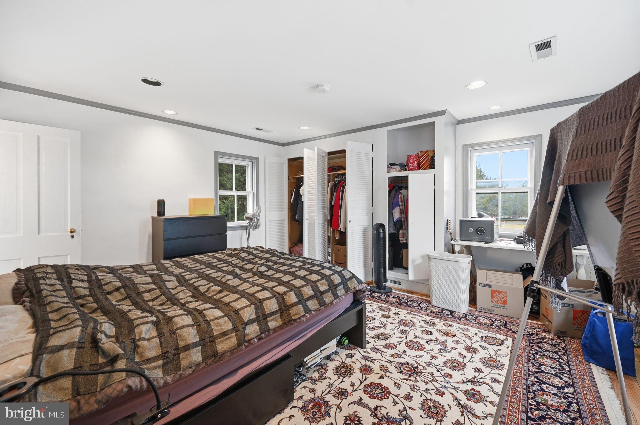 11641 Glen Road Potomac, MD 20854 - Photo 24 of 40 a bedroom with a large bed and a flat tv screen