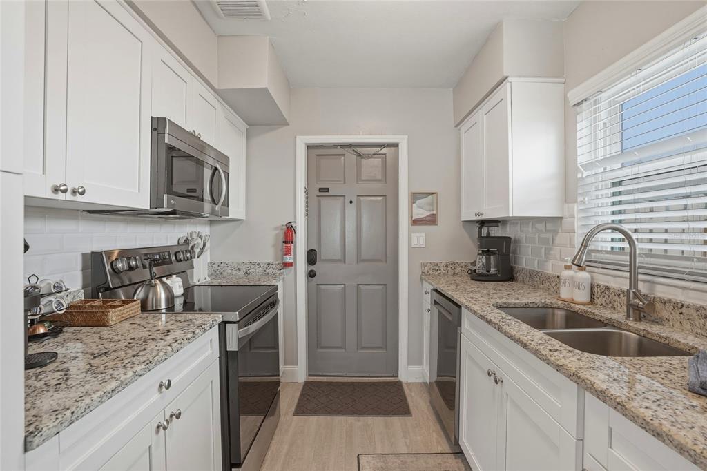 2605 Bay Boulevard Indian Rocks Beach, FL 33785 - Photo 15 of 82 a kitchen with a sink stove and refrigerator