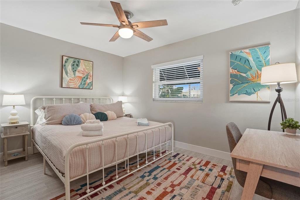 2605 Bay Boulevard Indian Rocks Beach, FL 33785 - Photo 20 of 82 a bedroom with a bed a window and a painting on the wall