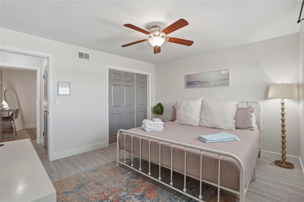 2605 Bay Boulevard Indian Rocks Beach, FL 33785 - Photo 21 of 82 a bedroom with a bed and a chandelier