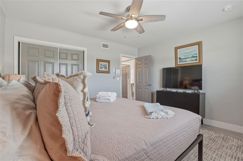 2605 Bay Boulevard Indian Rocks Beach, FL 33785 - Photo 27 of 82 a bedroom with a bed and a flat screen tv