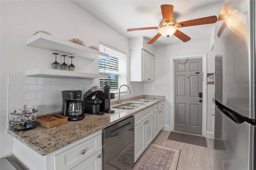 2605 Bay Boulevard Indian Rocks Beach, FL 33785 - Photo 33 of 82 a kitchen with stainless steel appliances granite countertop a sink a stove and a refrigerator