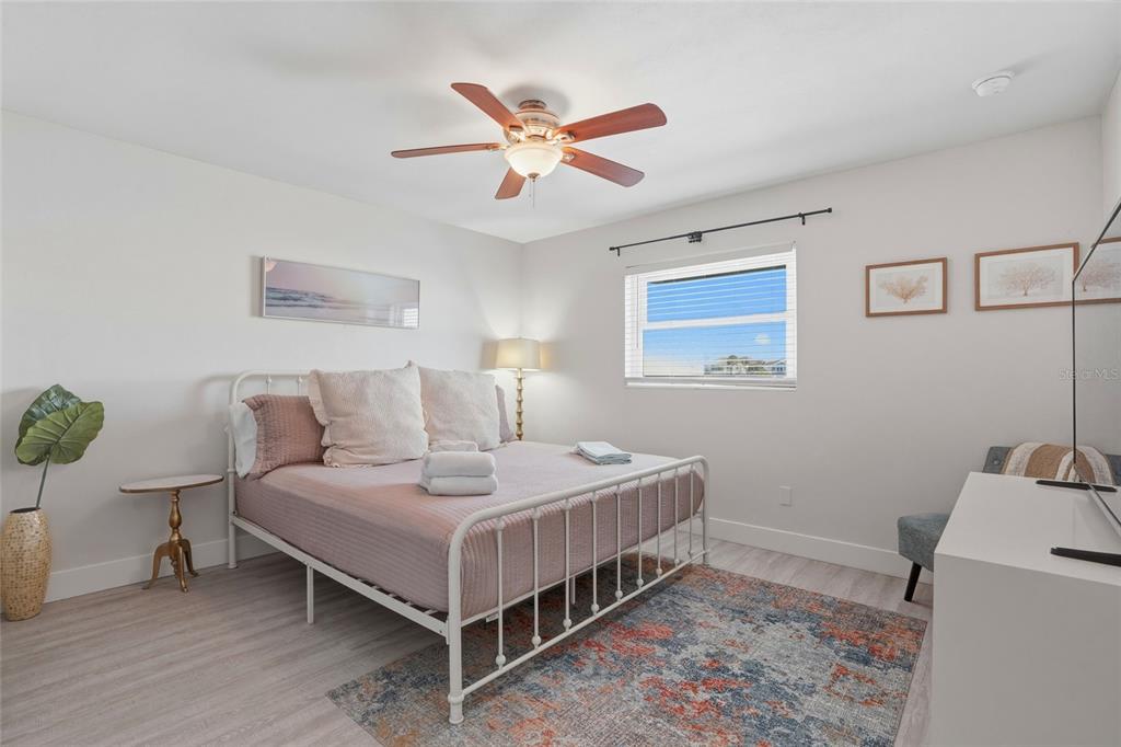 2605 Bay Boulevard Indian Rocks Beach, FL 33785 - Photo 39 of 82 a bedroom with a bed and a chandelier