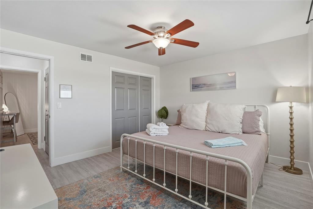 2605 Bay Boulevard Indian Rocks Beach, FL 33785 - Photo 40 of 82 a bedroom with a bed and a chandelier