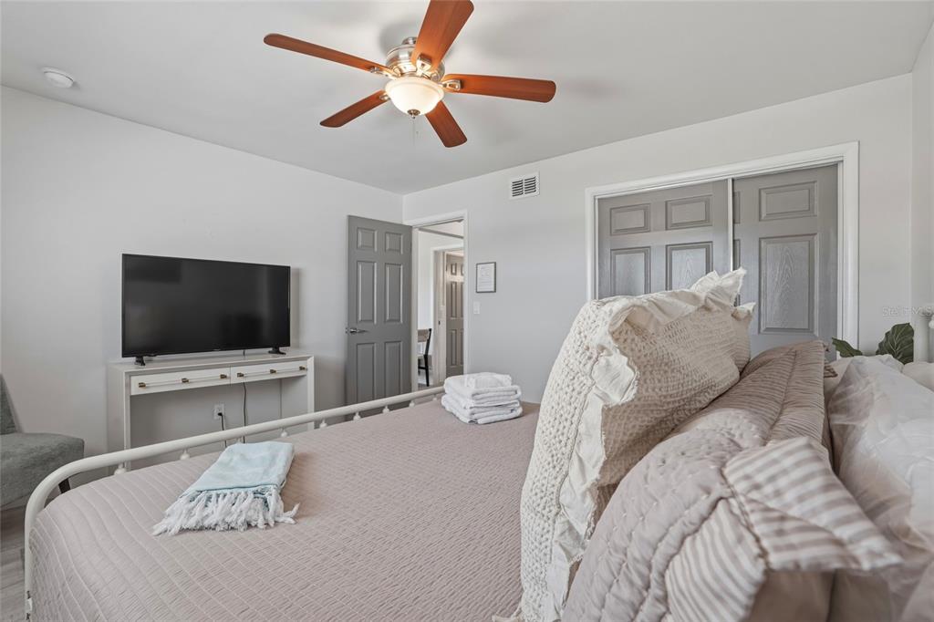 2605 Bay Boulevard Indian Rocks Beach, FL 33785 - Photo 41 of 82 a bedroom with a bed and a flat screen tv