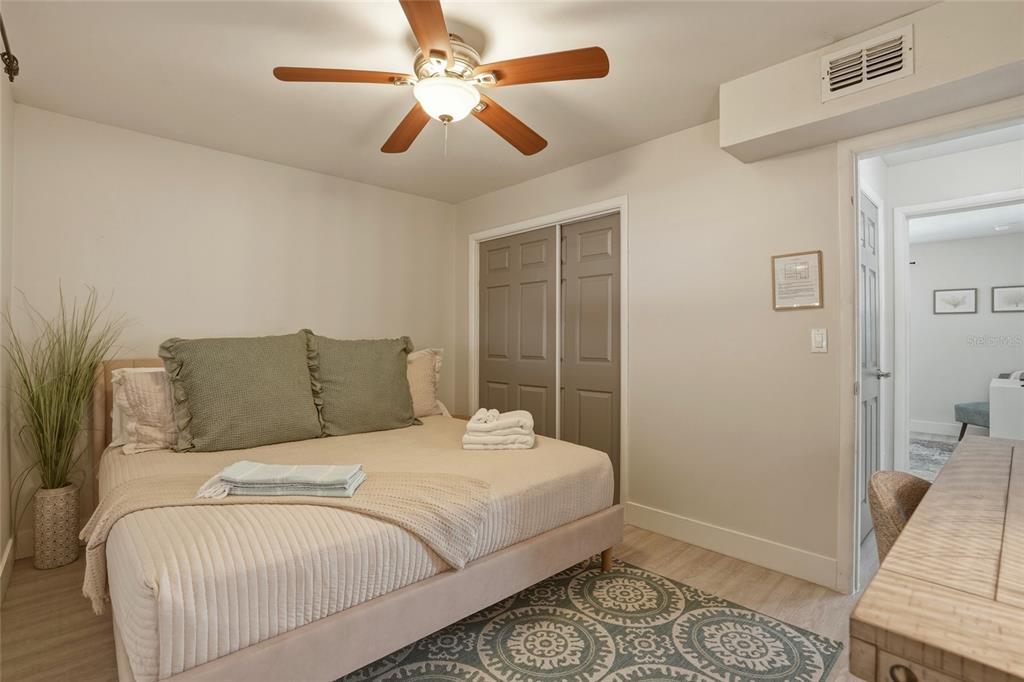 2605 Bay Boulevard Indian Rocks Beach, FL 33785 - Photo 46 of 82 a bedroom with a large bed and a chandelier