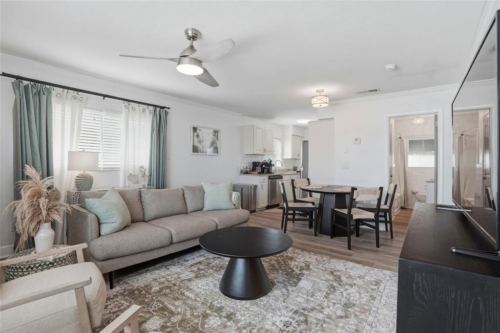 2605 Bay Boulevard Indian Rocks Beach, FL 33785 - Photo 57 of 82 a living room with furniture a large window and stainless steel appliances