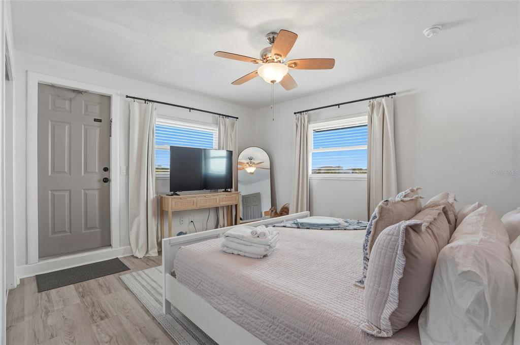 2605 Bay Boulevard Indian Rocks Beach, FL 33785 - Photo 59 of 82 a bedroom with a large bed and a chandelier