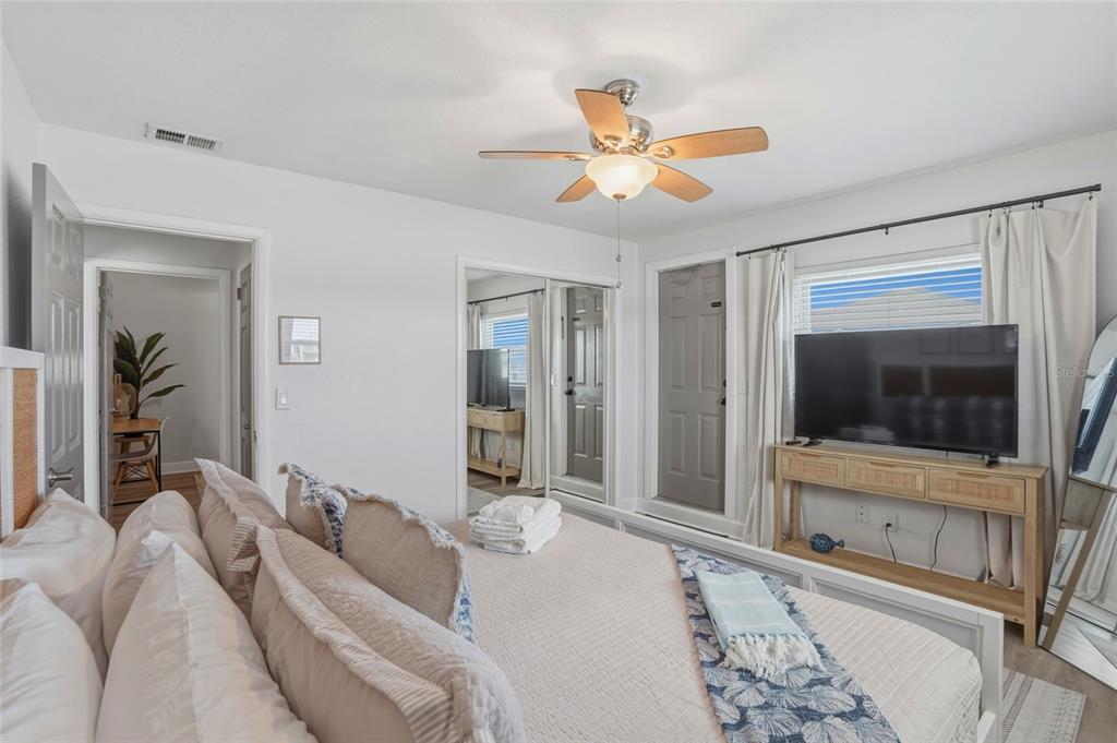 2605 Bay Boulevard Indian Rocks Beach, FL 33785 - Photo 60 of 82 a bedroom with a bed and a flat screen tv