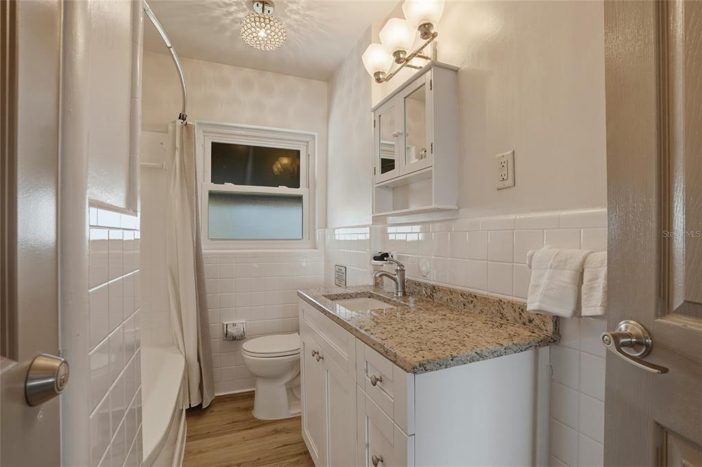 2605 Bay Boulevard Indian Rocks Beach, FL 33785 - Photo 65 of 82 a bathroom with a granite countertop sink and a mirror