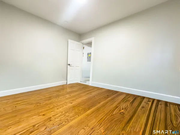 a spacious bedroom with a bed and a chair