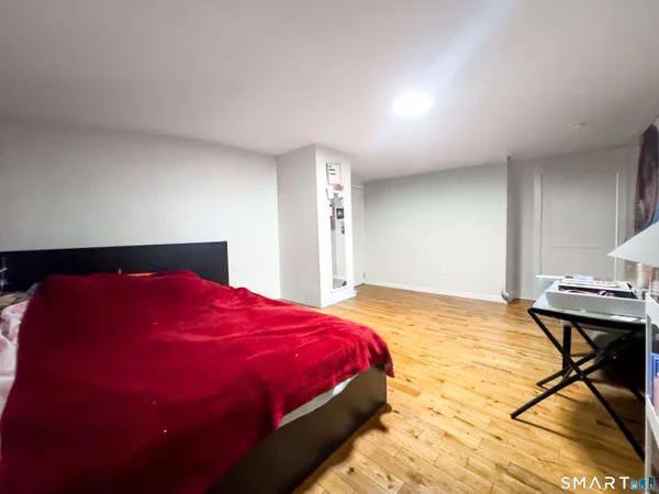 a bathroom with a sink vanity mirror bathtub and toilet