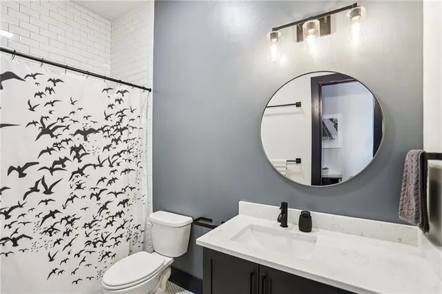 a bathroom with a sink toilet and mirror