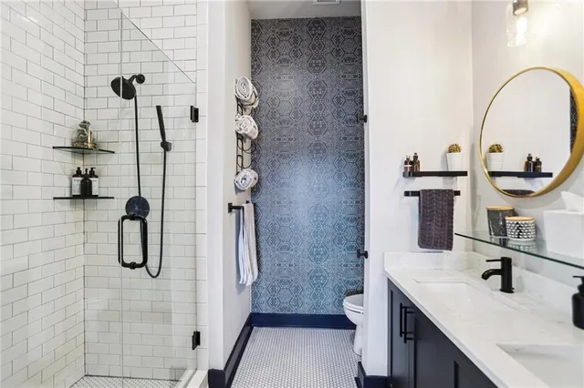 a bathroom with a sink a toilet and shower