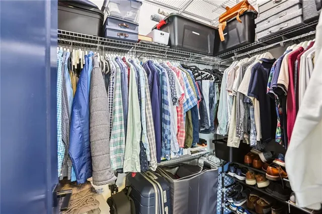 a view of walk in closet with clothes