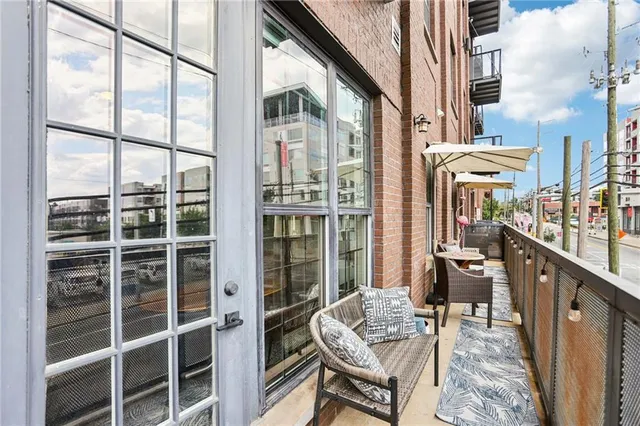 a view of a balcony with chairs and wooden floor