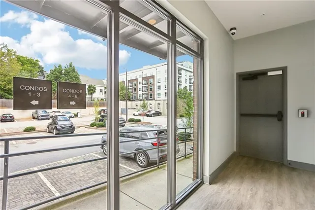 a patio with table and chairs and potted plants