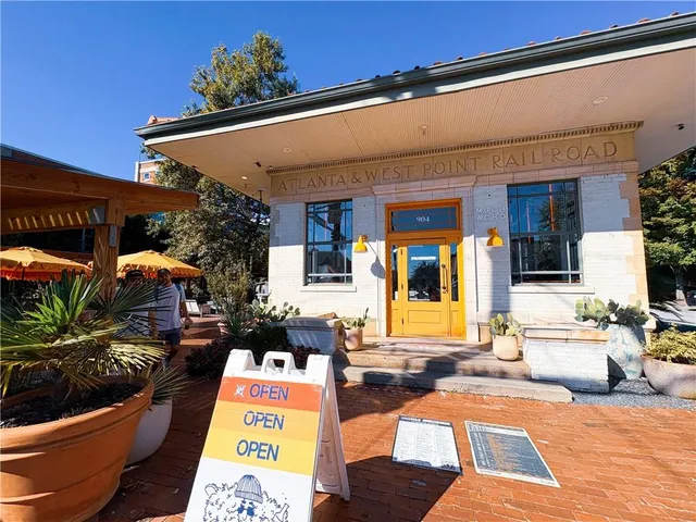 a view of a patio with dining table and chairs with wooden floor