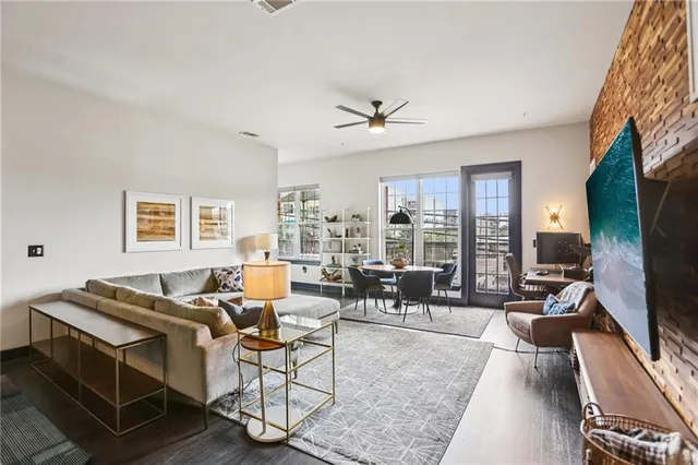 a living room with patio furniture and a flat screen tv